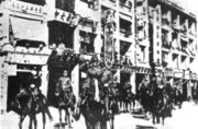 Japanese troops march along Queen's Road following the British surrender in 1941.