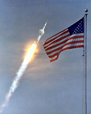 A condensation cloud forms around an interstage as the Saturn V approached Mach 1, one minute into the flight