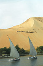 Tourists ride in traditional Nile boats.