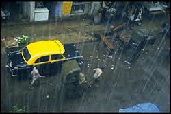 A view of rain falling on a street of Kolkata, India.