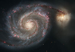 Strings of red H�II regions delineate the arms of the Whirlpool Galaxy.