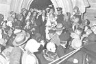 Hundreds of onlookers gather as the Bradmans leave the church after their wedding ceremony in 1932.