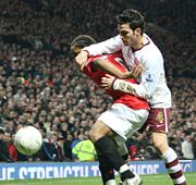 Spaniard Cesc F�bregas (white shirt, Arsenal) and Brazilian Anderson (red shirt, Manchester United) play in the English Premier League.