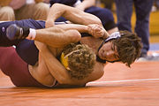 Two high school students competing in scholastic wrestling (collegiate wrestling done at the high school and middle school level).