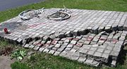 A memorial depicting a destroyed bicycle and a tank track — symbol of the Tiananmen Square protests — in the Polish city of Wrocław