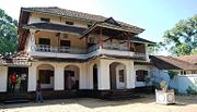 A typical Kerala-style house with a thulasi thara, a platform for tulasi, in the front.