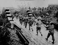 American soldiers cross the Siegfried Line, the border between Germany and France