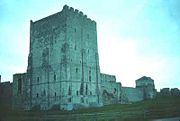 Portchester Castle at night, showing the Tower's uplighting.