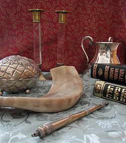 Judaica (clockwise from top): Shabbat candlesticks, handwashing cup, Chumash and Tanakh, Torah pointer, shofar, and etrog box