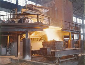 White-hot steel pouring out of an electric arc furnace.