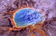 Wooden walkways allow visitors to closely approach the Grand Prismatic Spring.