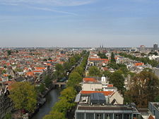 The Secret Annexe with its light-colored walls and orange roof (bottom) and the Anne Frank tree in the garden behind the house (bottom right), seen from the Westerkerk in 2004