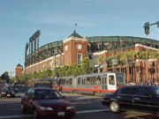 A Muni light rail vehicle passes AT&T Park, home of the San Francisco Giants.