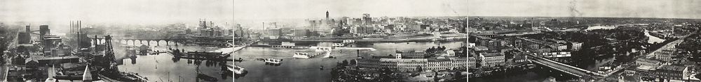 Mississippi riverfront and Saint Anthony Falls in 1915. At left, Pillsbury, power plants and the Stone Arch Bridge. Today the Minnesota Historical Society's Mill City Museum is in the Washburn "A" Mill, across the river just to the left of the falls. At center left are Northwestern Consolidated mills. The tall building is Minneapolis City Hall. In the foreground to the right are Nicollet Island and the Hennepin Avenue Bridge.