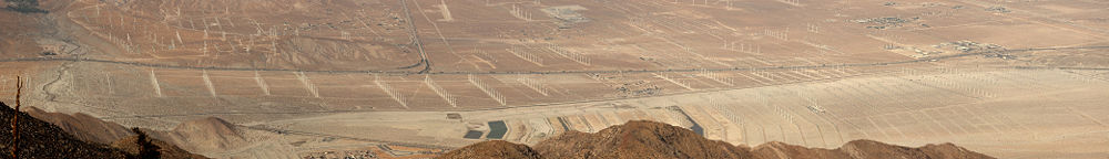 The majority of the San Gorgonio Pass Wind Farm as viewed from the San Jacinto Mountains to the south. (The farm continues over the hills to the north along California State Route 62 and is not visible from this vantagepoint). The layout includes a variety of large modern and older smaller turbine designs