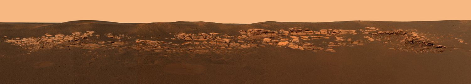 This panorama of Eagle crater shows outcroppings, which are thought to have water origins.