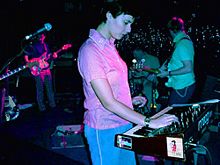 Lætitia Sadier of Stereolab playing a Moog synthesizer during a live performance