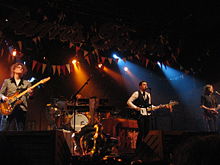 The Killers in concert in 2006. From left to right: Dave Keuning, Ronnie Vannucci Jr. (back), Brandon Flowers, and Mark Stoermer.