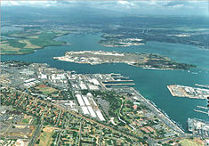 Aerial view of Pearl Harbor, Ford Island in center. The Arizona memorial is the small white dot on the far right side close to Ford Island.