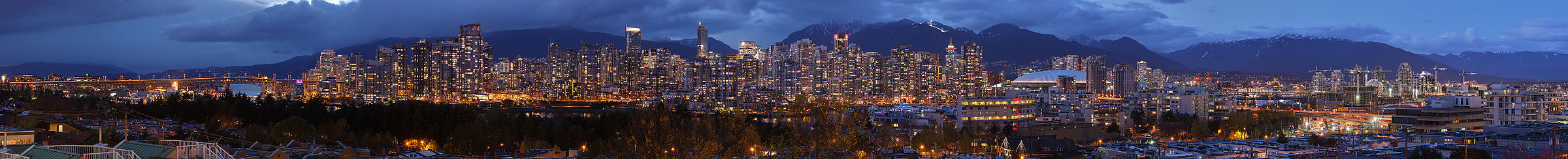 A high resolution panorama of Vancouver with the mountains behind, looking roughly north from the vicinity of Broadway and Oak Street.  The bridge on the left of the image is the Granville Street Bridge.