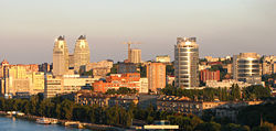 Modern apartment blocks dominate the shoreline of the Dnieper River in the city.