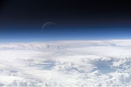 Atmospheric gases scatter blue light more than other wavelengths, giving the Earth a blue halo when seen from space