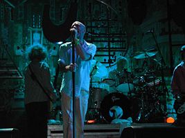 R.E.M. in concert in Padova, Italy, July 22, 2003. From left to right: Mike Mills, Michael Stipe, touring drummer Bill Rieflin, and Peter Buck.