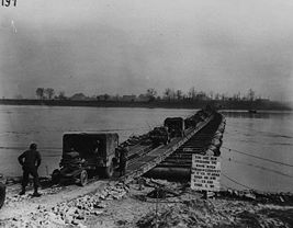 The U.S. 9th Army crosses the Rhine on a temporary steel treadway pontoon bridge, 1945.