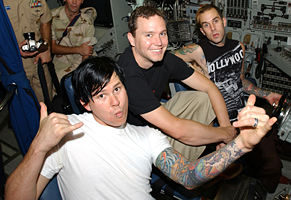 Left to right: Tom DeLonge, Mark Hoppus and Travis Barker visit US soldiers stationed in Manama, Bahrain in August 2003