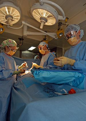 US Navy surgeon performs a hernia repair surgery while at sea