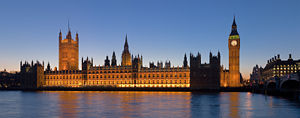 The Palace of Westminster—at dusk, showing the Victoria Tower (left) and the Clock Tower, colloquially known as "Big Ben"—lies on the bank of the River Thames in the heart of London.