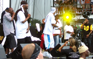 Members of the Wu-Tang Clan and their affiliates performing at the Virgin Festival in Baltimore. From left: Mathematics (background), Inspectah Deck, Streetlife, U-God, Cappadonna (crouched), Method Man, GZA, Raekwon, and RZA.