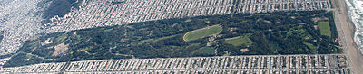 An aerial view (facing south) of Golden Gate Park from The Panhandle (at far left edge of picture) to the Pacific Ocean