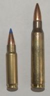 Photo of the 5.7x28mm SS197SR cartridge next to a 5.56x45mm NATO cartridge. The 5.56x45mm cartridge is significantly larger.