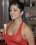 A black-haired woman wearing a red dress.