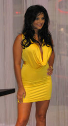 A woman shown in three-quarter length, wearing a yellow mini-dress