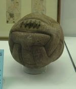 Another aged ball, slightly lighter in colour and more worn. Near the top are five vertical stitches