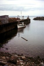 Photo of boat in water next to a dock