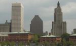 Three buildings, two of the same stature, and one smaller than the others.