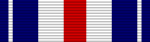 A multicolored military ribbon. From left to right the color pattern is; thin blue stripe, thin white strip, thick blue stripe, thinck white stripe, thick red stripe, thick white stripe, thick blue stripe, thin white strip, thin blue stripe.