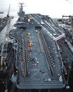 Lincoln in drydock. Equipment and vehicles are on deck for the overhaul