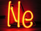 Illuminated orange gas discharge tubes shaped as letters N and e