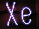 Illuminated violet gas discharge tubes shaped as letters X and e