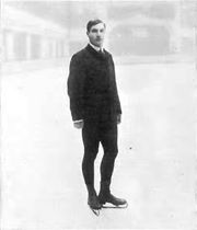 a man standing on ice in figure skates