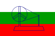 A tricolour flag of white, green and red with a spinning wheel in the centre