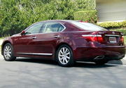 Aft profile view of sedan parked on a street.