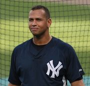 Portrait of a young man wearing a dark blue shirt with an interlocking white "N" and "Y" on the upper left of the chest.