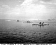 A black and white photograph showing four ships at various distances sailing from the right to the left.