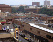 Aerial view of a city downtown, showing the Michigan Theater and a Borders in the foreground, and several buildings amongst trees in the background