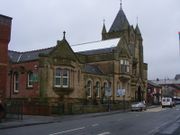 The facade of Ashton town library, constructed from stone and built in Gothic revival style